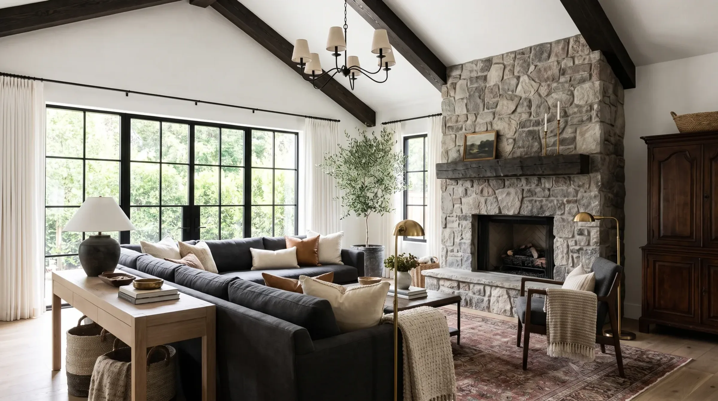 Quiet European living room in limestone and pale oak with a sculptural arch, designed by Élara & Co. in Bangalore